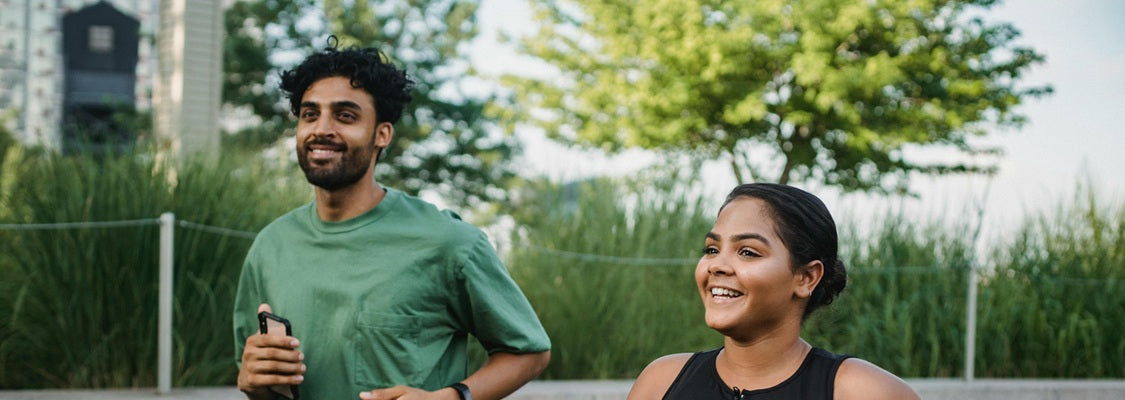 A couple is exercising outdoors