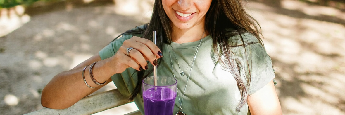 A woman with a purple drink