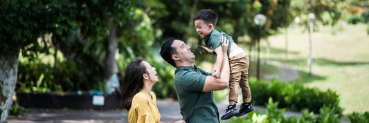 A father, mother and child in a park