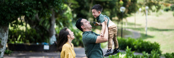 A father, mother and child in a park