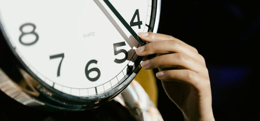 Person Holding White Analog Clock
