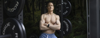 Bryan Johnson posing in front of weights